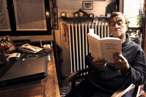 Lucio all'interno di casa mentre legge un libro